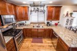 Granite countertops and stainless steel appliances in this charming kitchen 